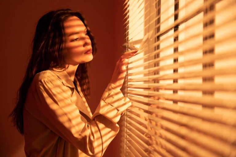 beautiful-young-woman-window-blinds